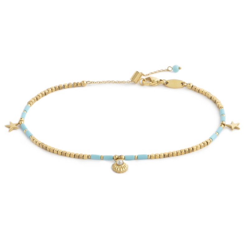 Cavigliera con ematite cubica alternata a perline conchiglia e stelle marine pendenti base gialla