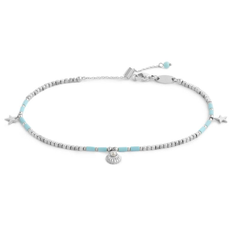 Cavigliera con ematite cubica alternata a perline conchiglia e stelle marine pendenti base bianca