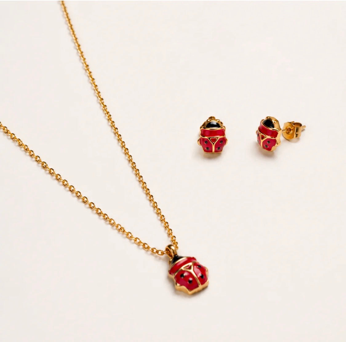 PARURE COCCINELLA ROSSA ACCIAIO DORATO